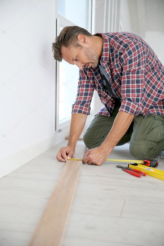 man  installing new wooden floor