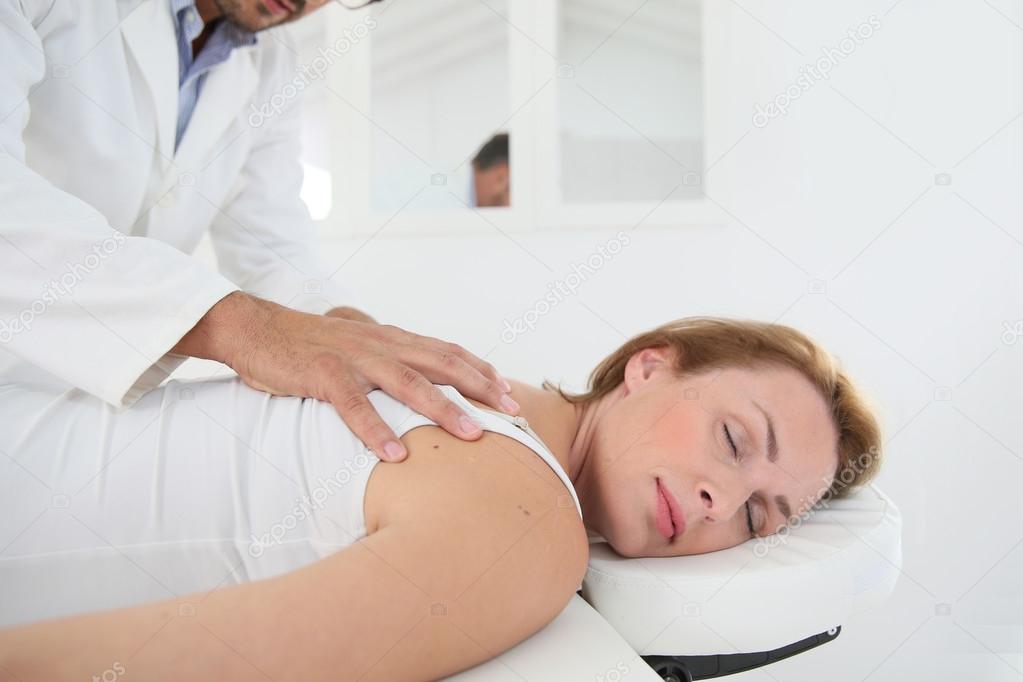 Chiropractor checking spine