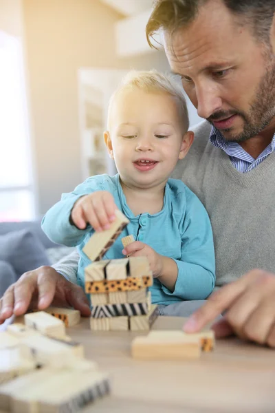 Boy playing with wooden blocks — Stock Photo, Image