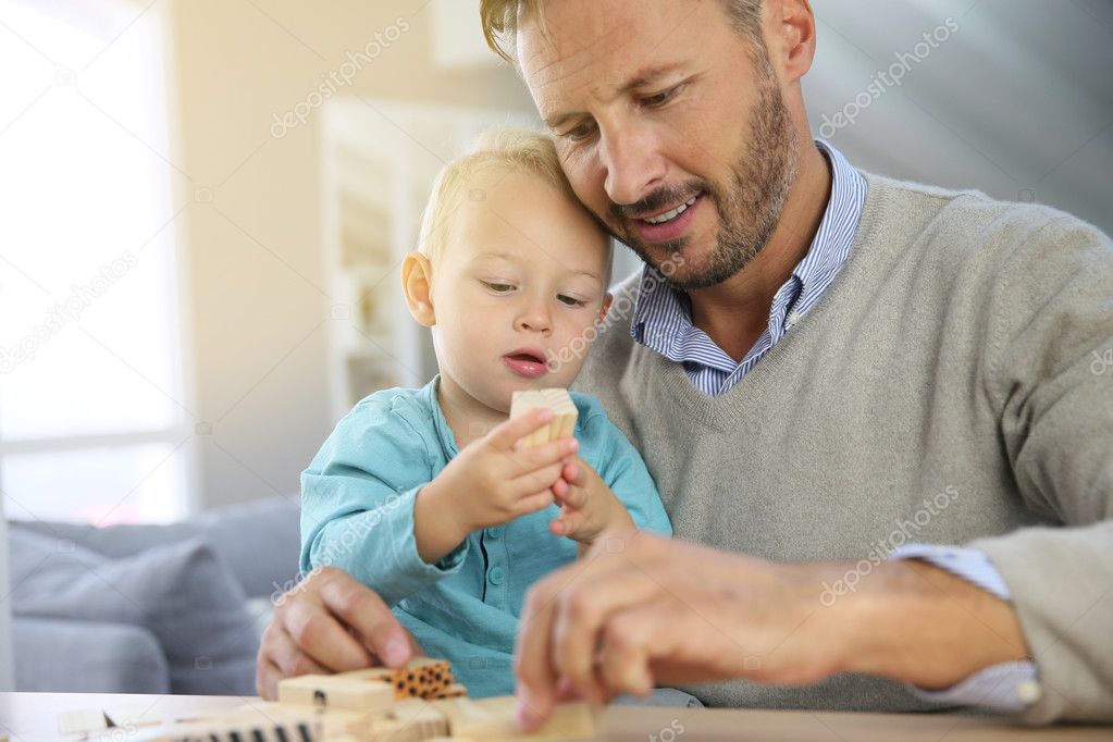 boy playing with wooden blocks