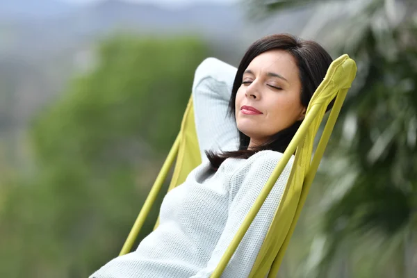 Woman relaxing in long chair — Stock Photo, Image
