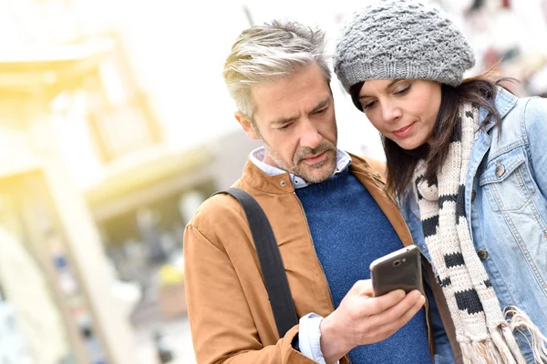 Casal na cidade usando smartphone Fotos De Bancos De Imagens