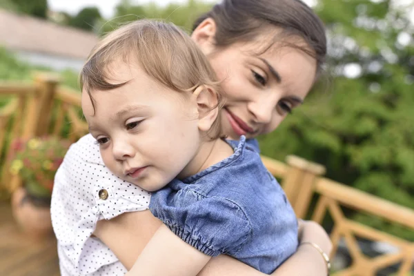 Lány ad az anyja egy ölelés — Stock Fotó