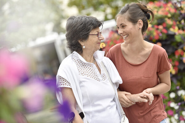 Home carer helping disabled woman