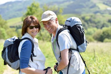 smiling mature  couple of hikers clipart
