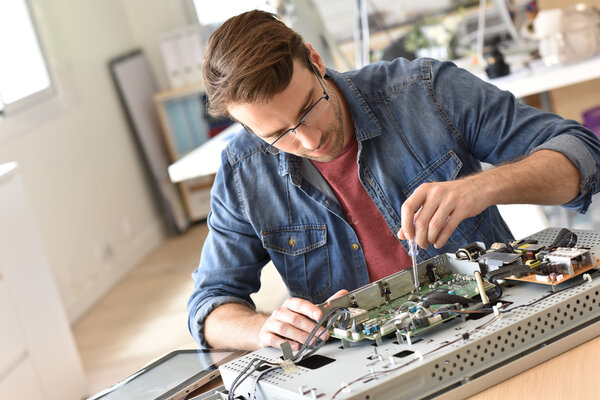 Repairman fixing tv set