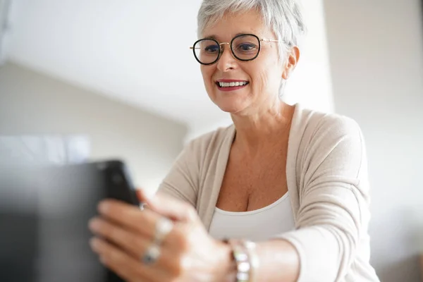 Cheerful Mature Woman Eyeglasses Using Digital Tablet Stock Photo