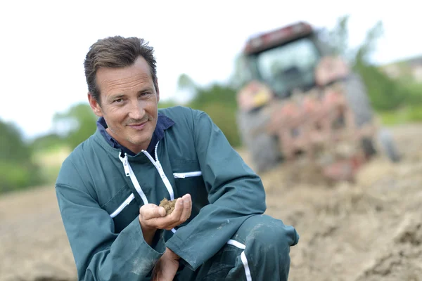 Farmer checking on cultivated ground quality — Stock Photo, Image