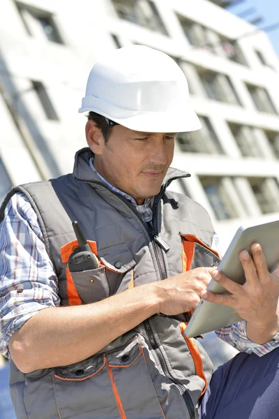 Entrepreneur sur le chantier à l'aide d'une tablette — Photo