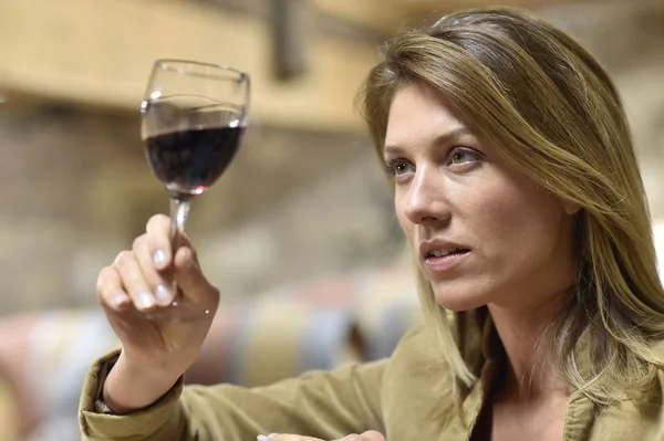 Mujer degustación de vino tinto en bodega — Foto de Stock