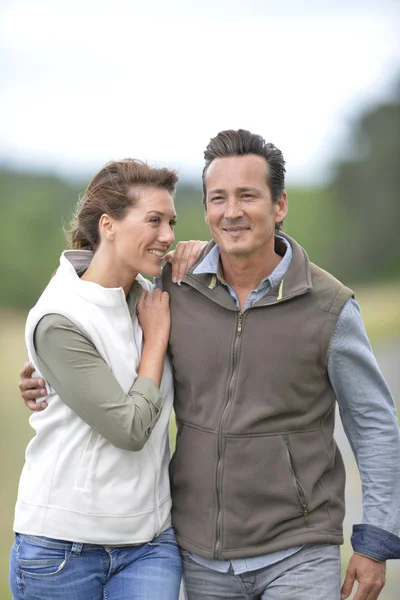 Couple walking in countryside Royalty Free Stock Images