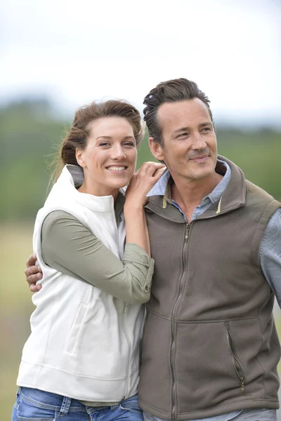 Couple walking in countryside Stock Picture