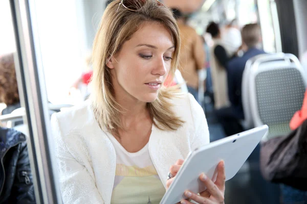 Woman in city train with tablet — Stock Photo, Image