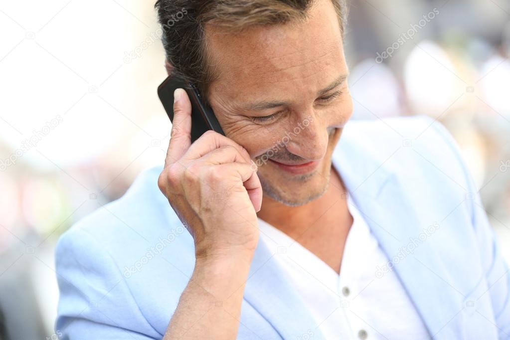Mature man talking on phone
