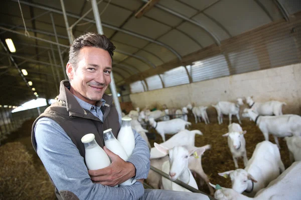 Farmer holding bottles of milk — Stock Photo, Image