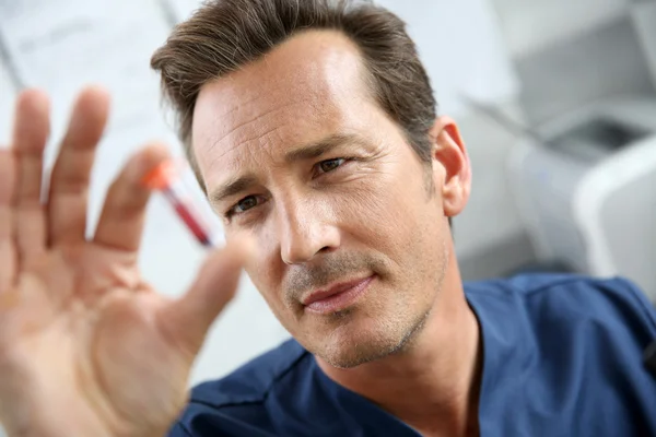 Doctor checking on blood sample — Stock Photo, Image