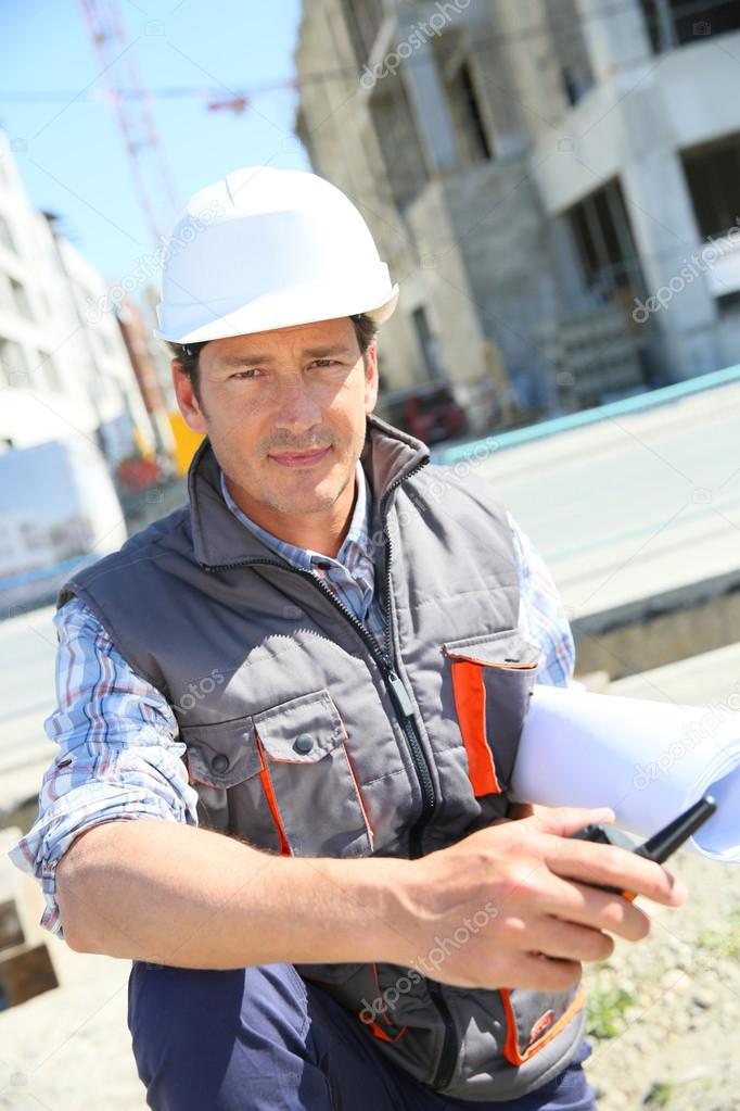 Entrepreneur on building site using tablet