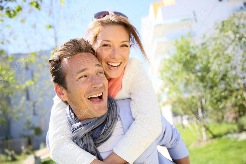 Man giving piggyback ride to woman