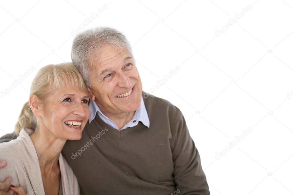 Senior couple looking on one side