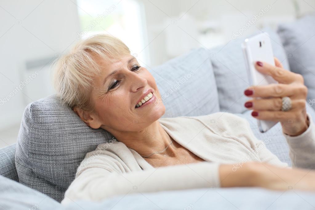 Woman reading message on smartphone