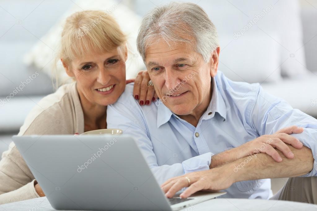 Couple websurfing on internet with laptop