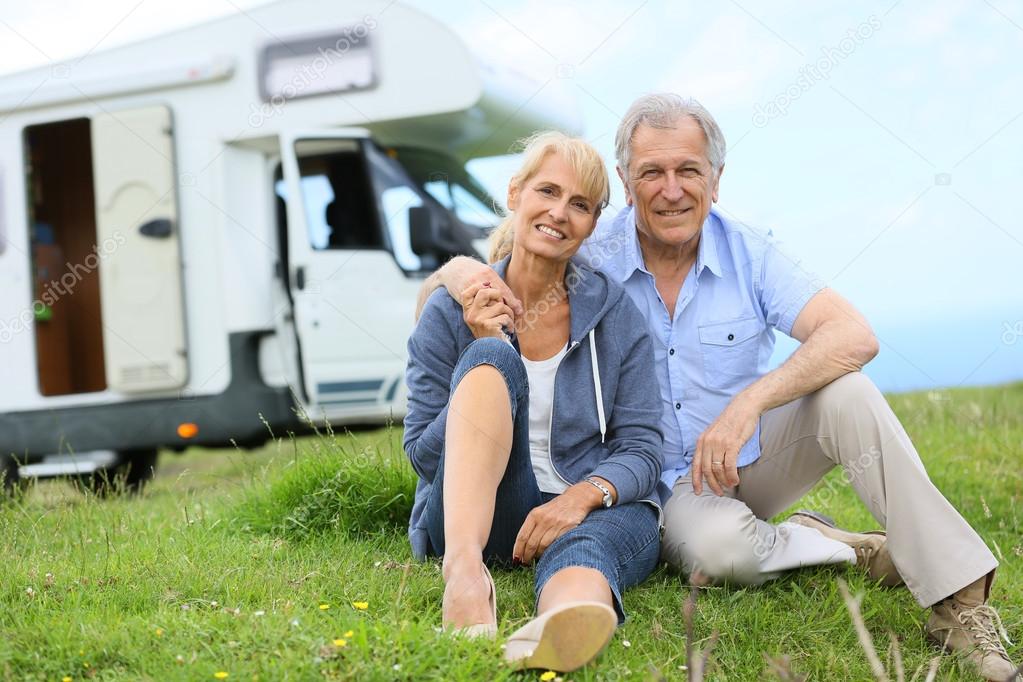 Senior couple sitting in grass