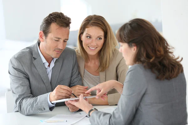 Couple signing loan grant — Stock Photo, Image