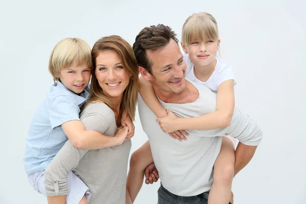 Parents giving piggyback ride to kids — Stock Photo, Image