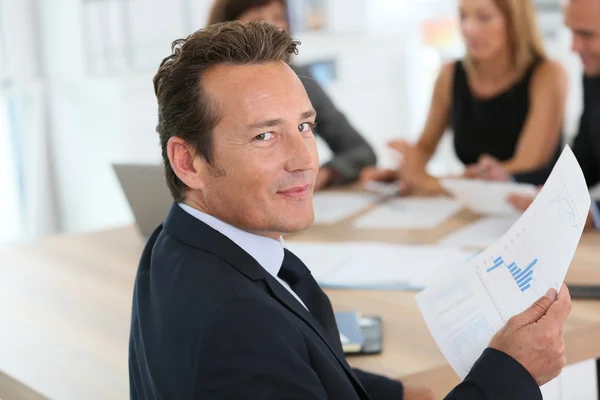 Corporate man sitting at meeting table