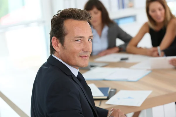 Corporate man sitting at meeting table — Stock Photo, Image