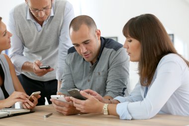 Business group meeting with smartphones clipart