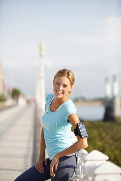 Jogger stretching after exercising in street — Stock Photo, Image