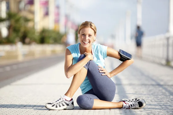 Jogger stretching after exercising in street — Stock Photo, Image