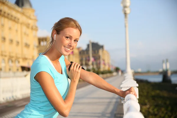 Woman stretching out after running — Stock Photo, Image