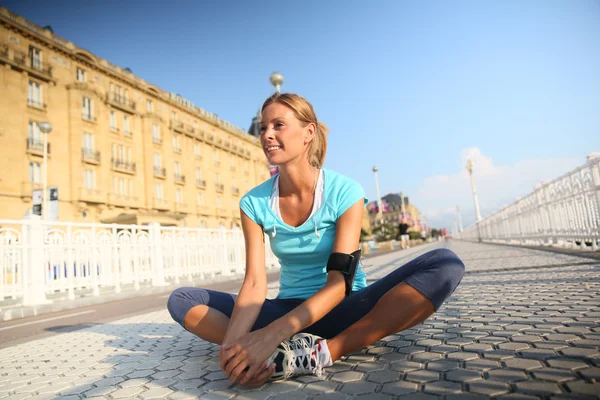 Woman stretching out after running — Stock Photo, Image