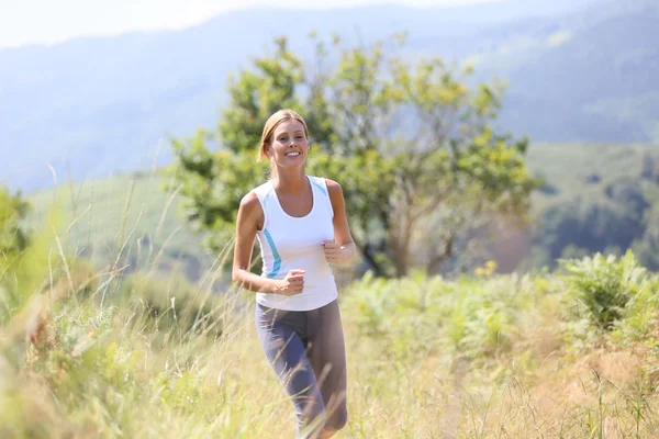 Donna che corre in campagna — Foto Stock