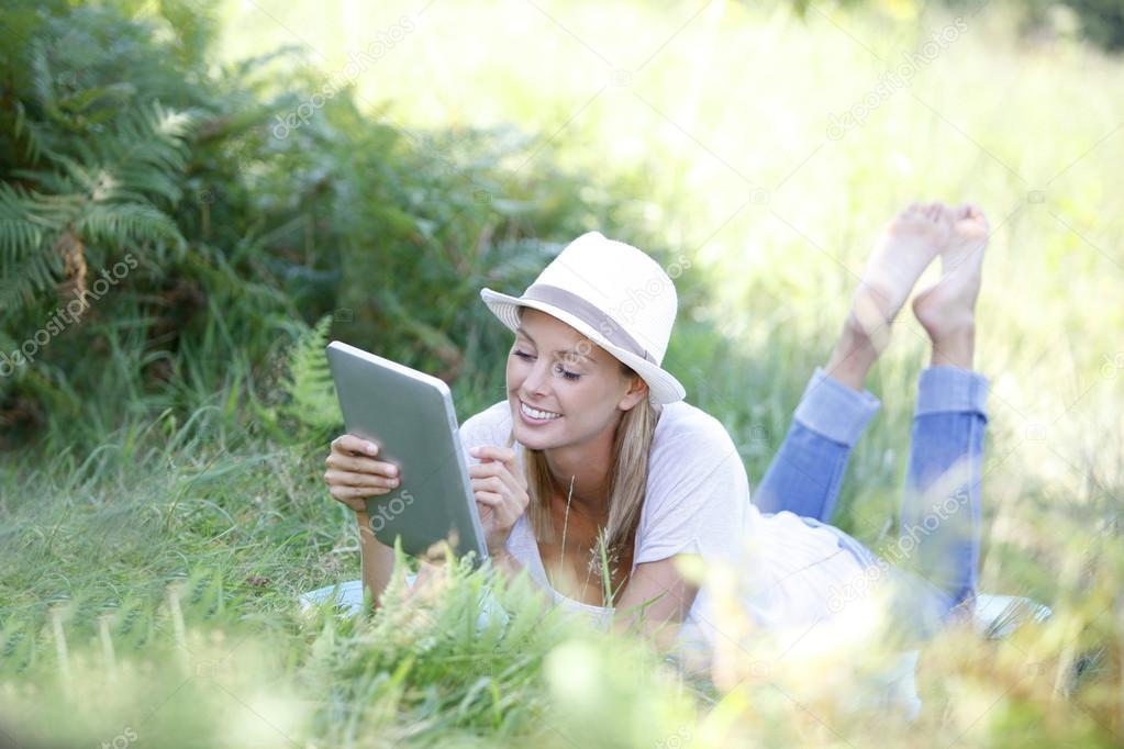 Woman using digital tablet in field