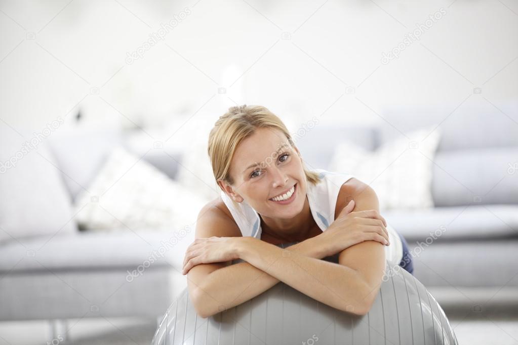 Woman relaxing on gym ball