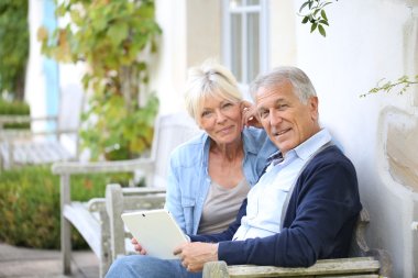 Senior couple websurfing on internet clipart