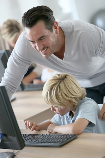 Teacher with boy in computers's lab — Stock Photo, Image