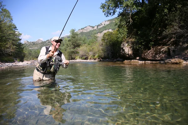 Fisherman fishing in freshwater river — Stock Photo, Image