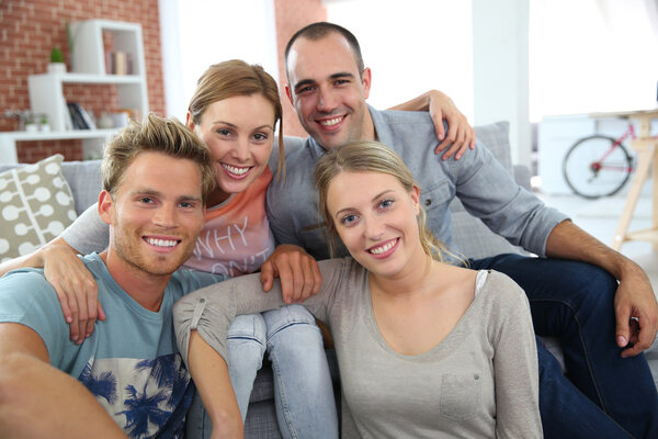 Roommates sitting together in couch