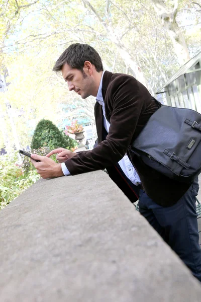 Businessman using digital tablet in park — Stock Photo, Image