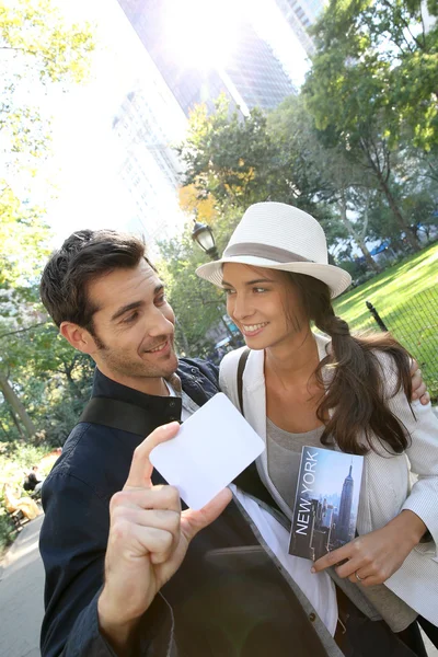 Tourists holding New York City pass — Stock Photo, Image