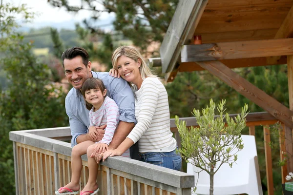 Family enjoying vacation in log cabin — Stock Photo, Image