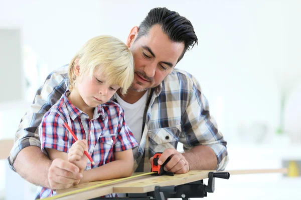 Vater mit Kind beim Holzplanken messen — Stockfoto