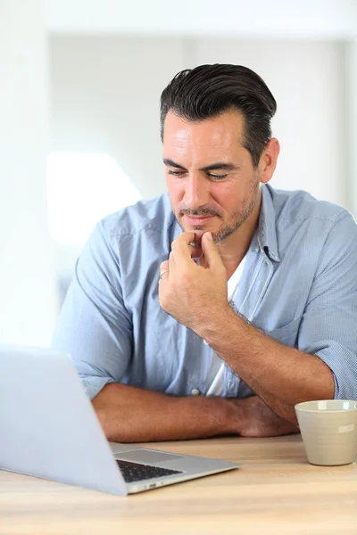 Man working at home with laptop — Stock Photo, Image