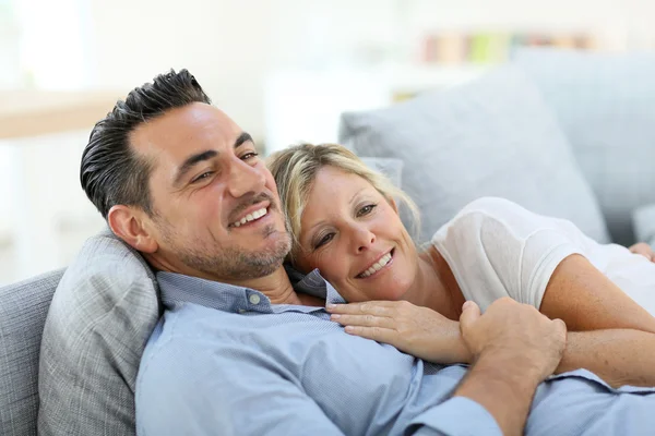 Mature couple relaxing in sofa — Stock Photo, Image