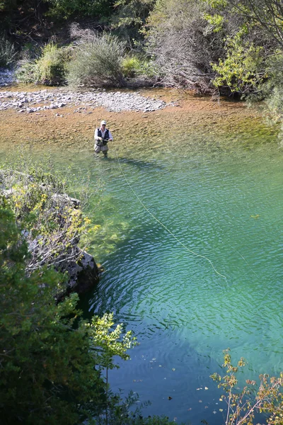 Fisherman fly-fishing in river — Stock Photo, Image