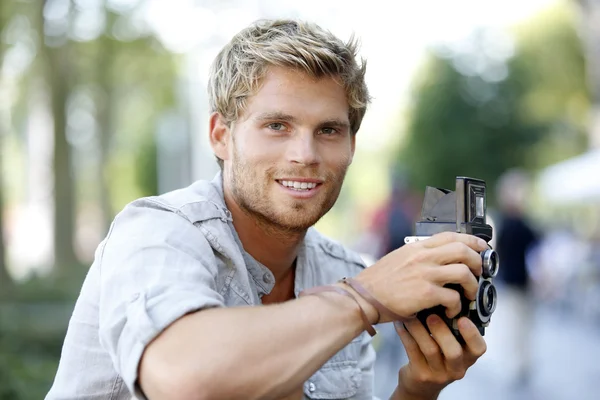 Trendy photographer using vintage camera — Stock Photo, Image